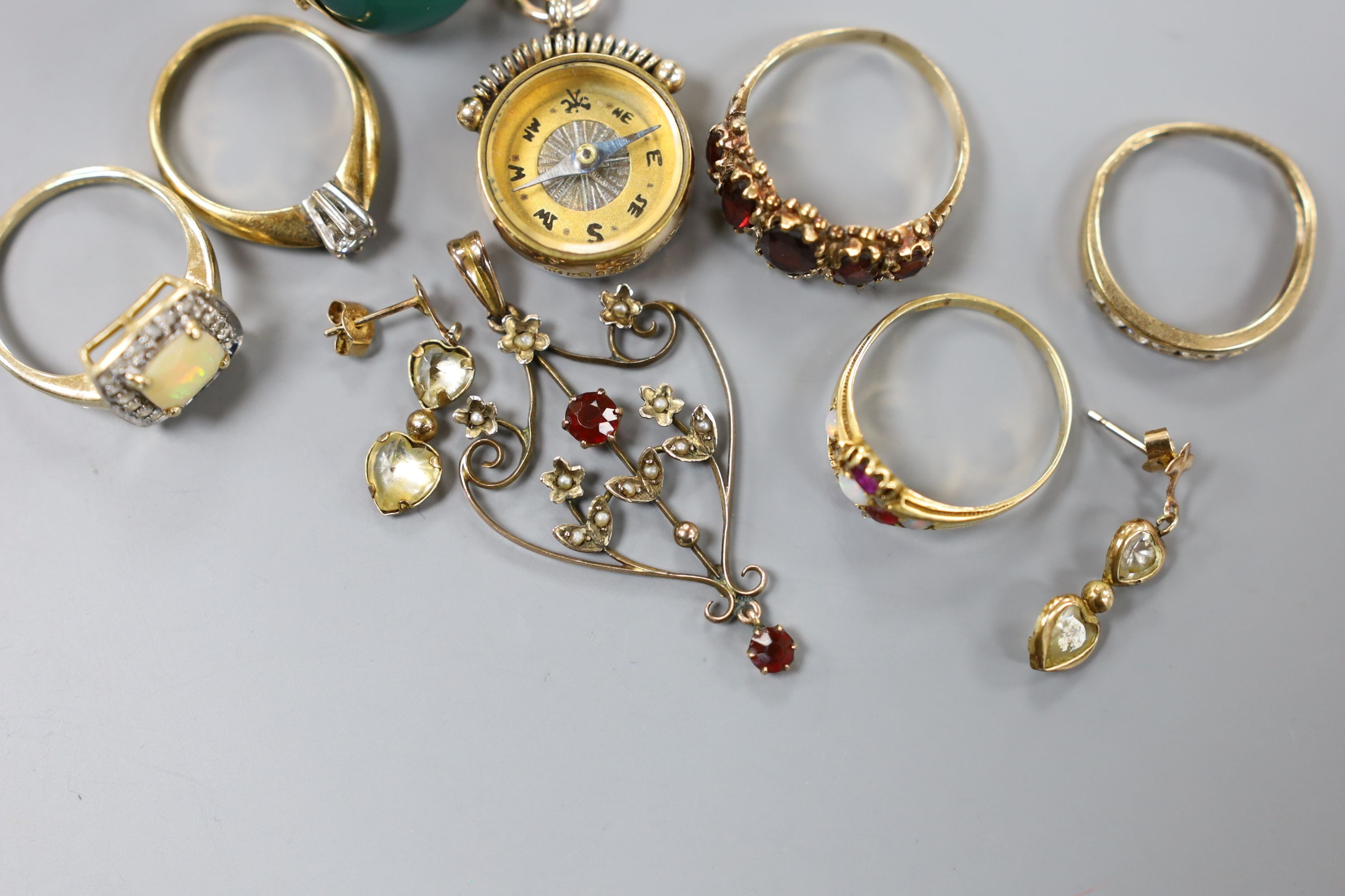 Five assorted modern 9ct gold and gem set rings, a 9ct gold mounted compass fob, a 9ct and gem set pendant and pair of 375 earrings, gross 26.7 grams, together with two yellow metal and gem set rings including five stone